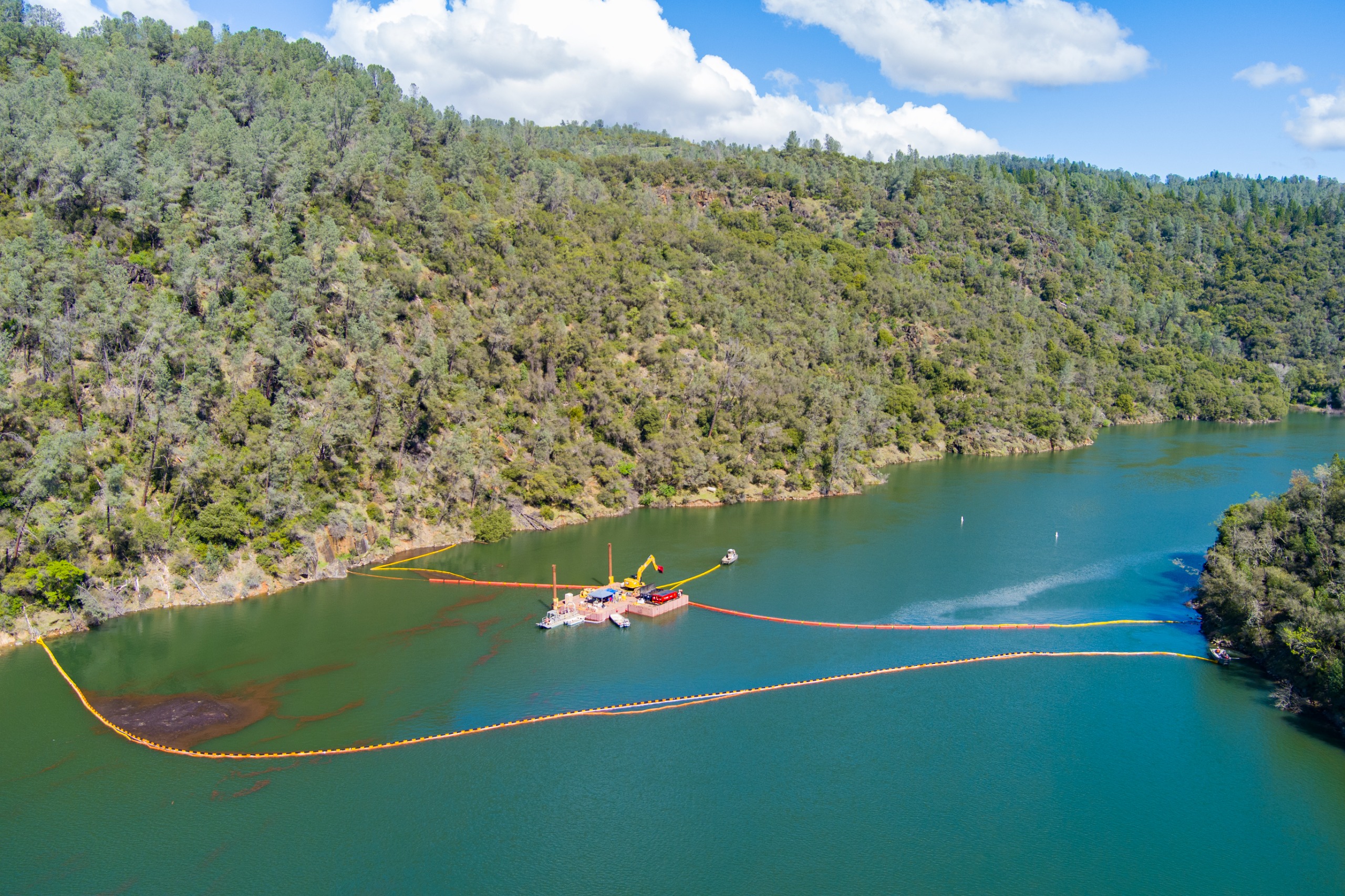 An aerial view of debris removal operations on Lake Englebright.